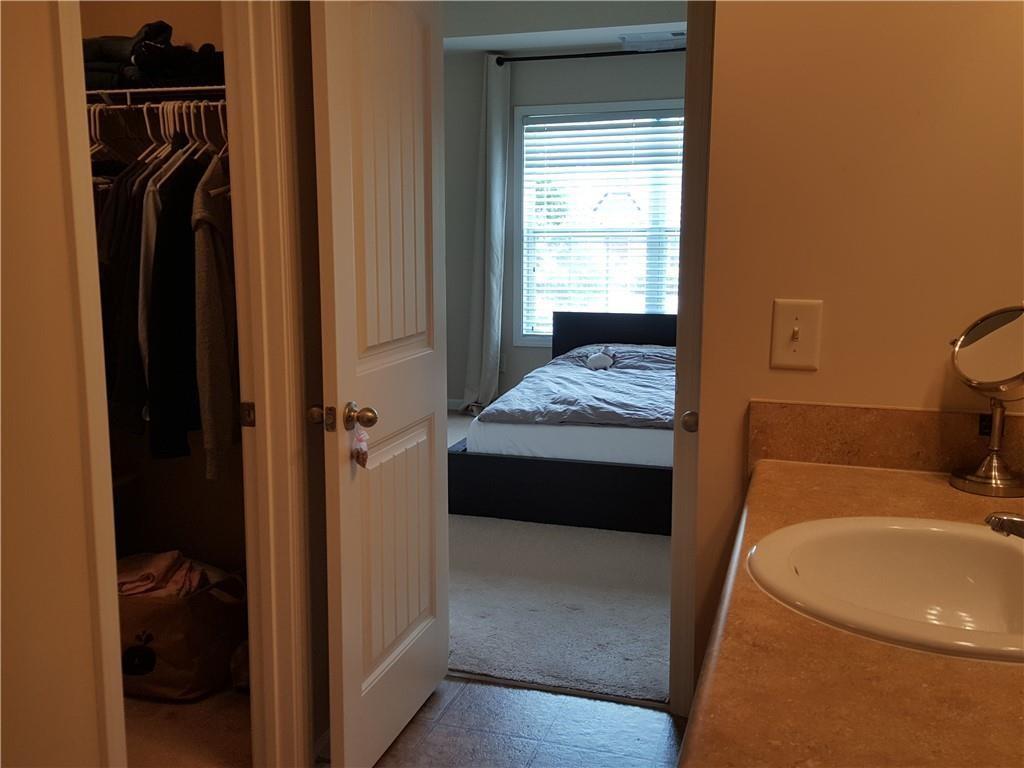 805 Pleasant Hill Road, Unit 330 Lilburn, GA 30047 - Photo 17 of 24 a en suite bathroom with a sink and a bath tub
