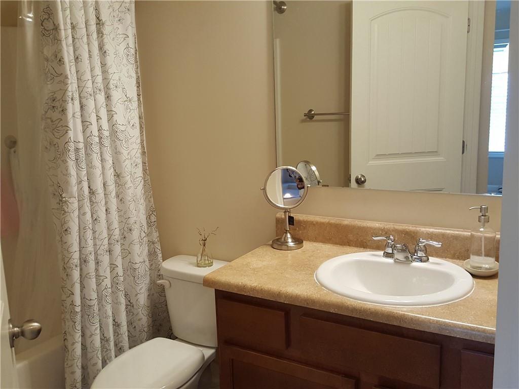 805 Pleasant Hill Road, Unit 330 Lilburn, GA 30047 - Photo 19 of 24 a bathroom with a sink toilet and a mirror