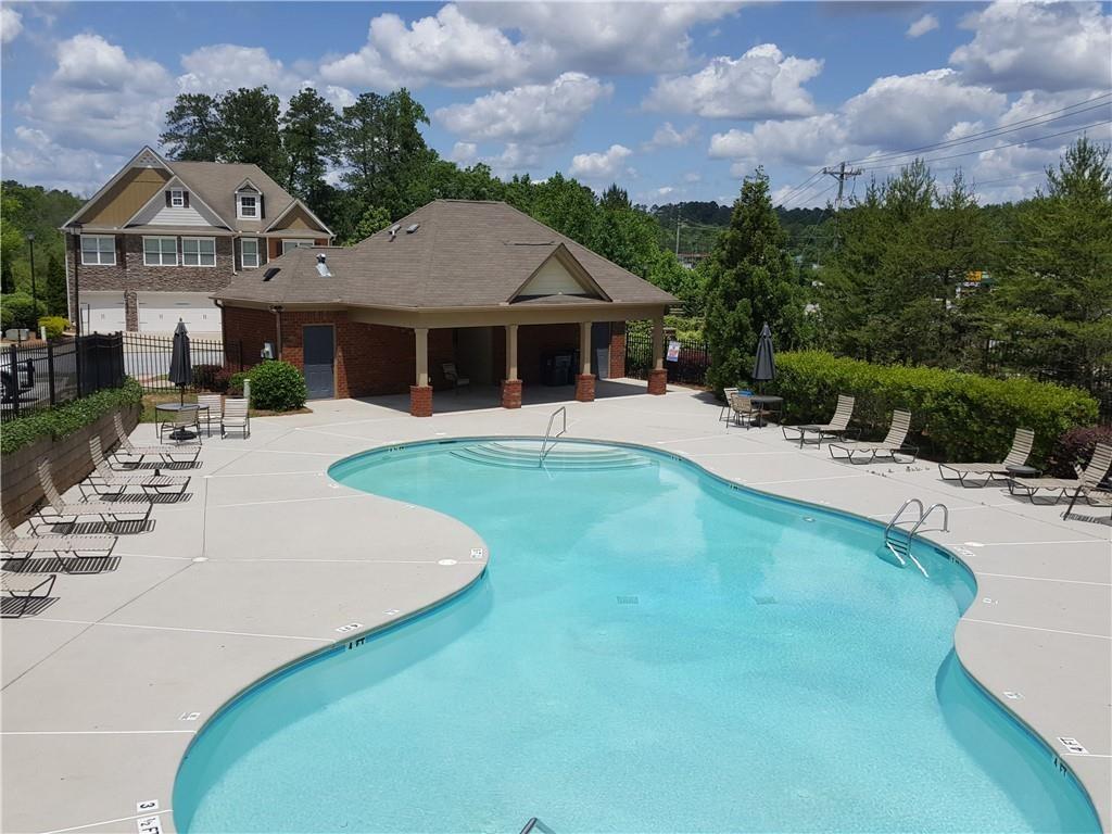 805 Pleasant Hill Road, Unit 330 Lilburn, GA 30047 - Photo 21 of 24 a front view of a house with a yard and garage