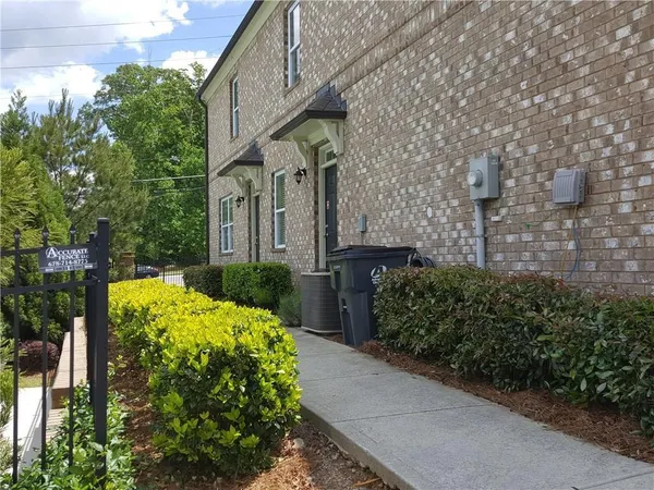 a view of a garden with brick wall