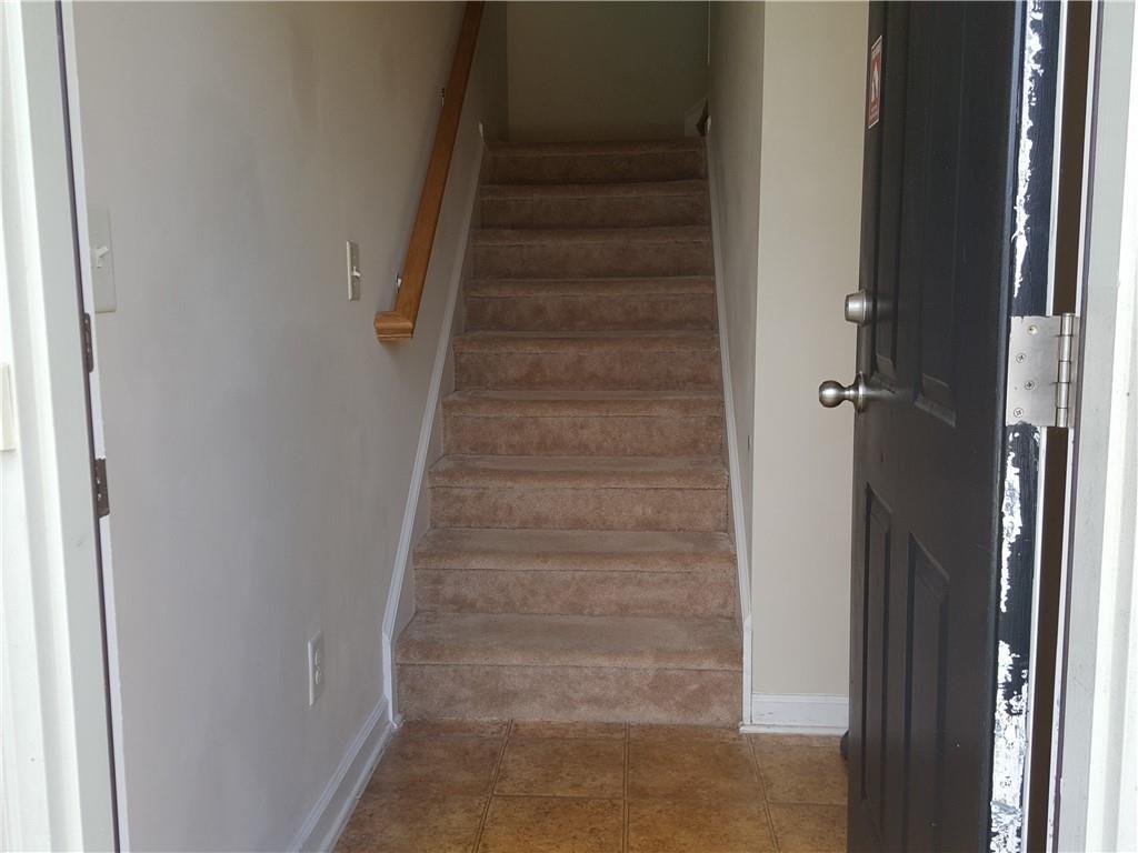 805 Pleasant Hill Road, Unit 330 Lilburn, GA 30047 - Photo 5 of 24 a view of staircase with white walls and white door