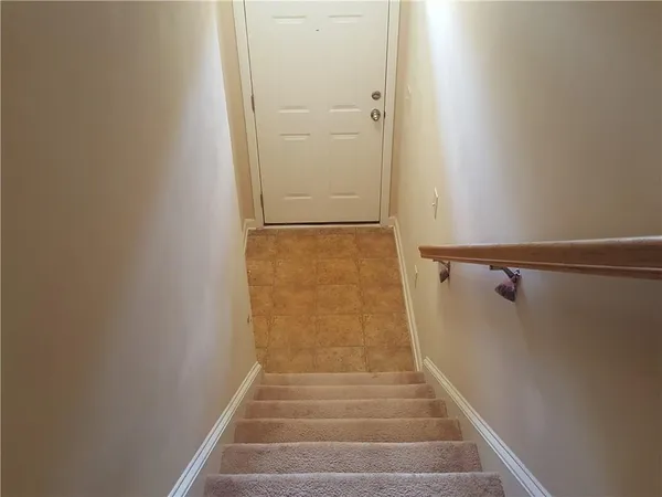 a view of staircase with white walls