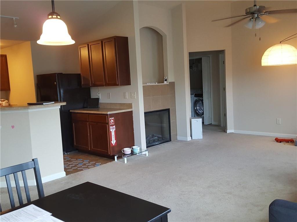 805 Pleasant Hill Road, Unit 330 Lilburn, GA 30047 - Photo 7 of 24 a kitchen with cabinets and a fireplace