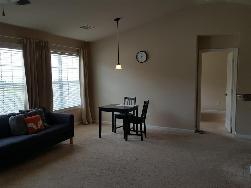 805 Pleasant Hill Road, Unit 330 Lilburn, GA 30047 - Photo 9 of 24 a living room with furniture and a large window