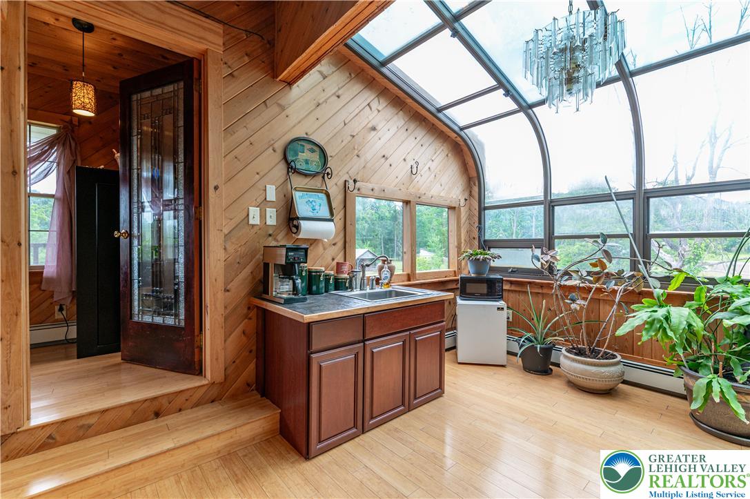 2485 Hieter Road Quakertown, PA 18951 - Photo 37 of 97 A radiant sunroom with soaring vaulted ceilings offers a cozy kitchenette and abundant natural light.