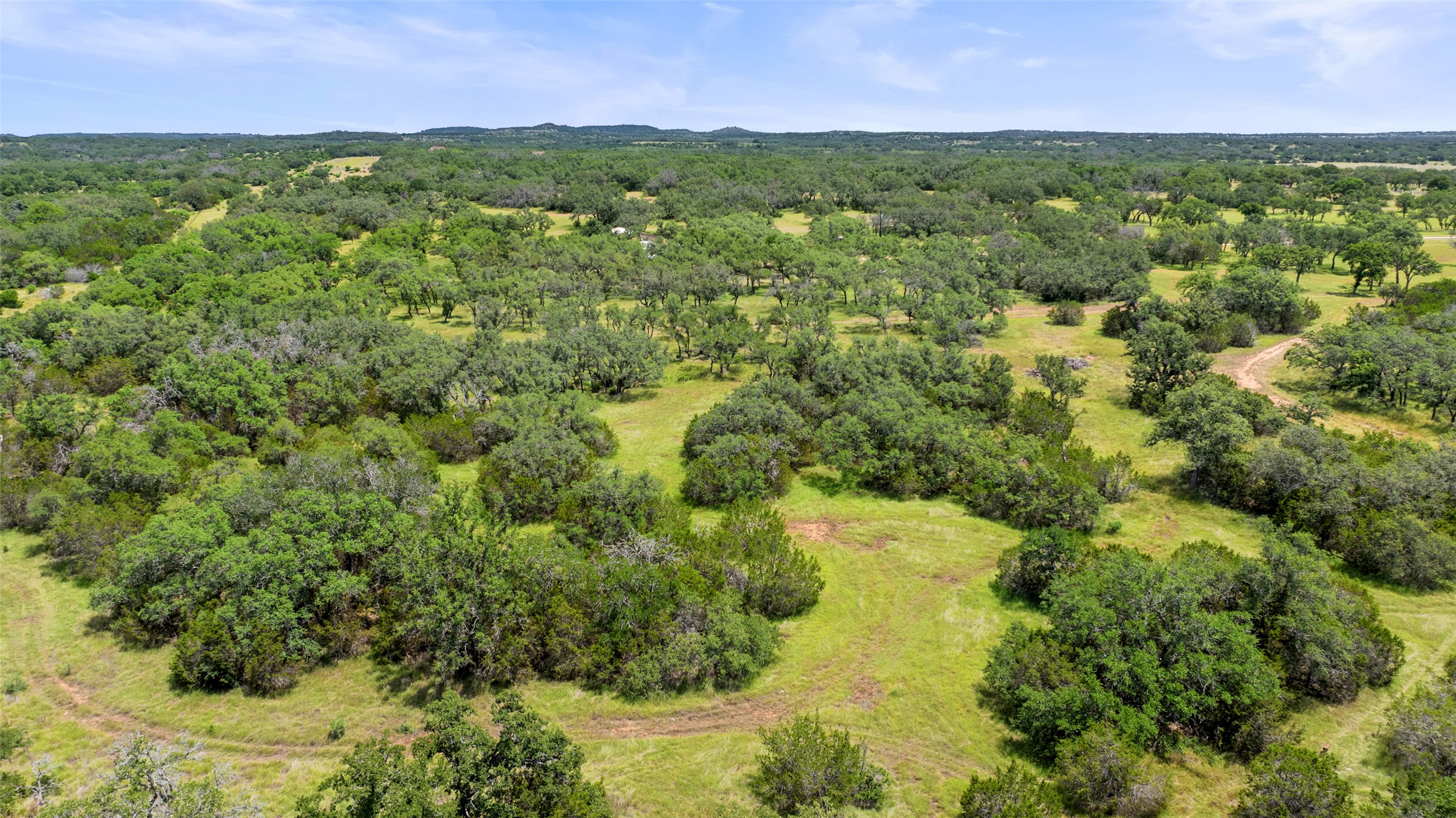 997 Sandy Oaks Ranch Road Johnson City, TX 78636 - Photo 8 of 11 a view of a city with lush green forest
