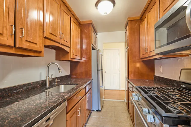 a kitchen with granite countertop a stove and a sink