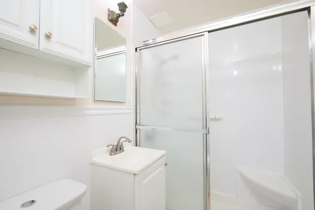 a bathroom with a sink a shower and a mirror