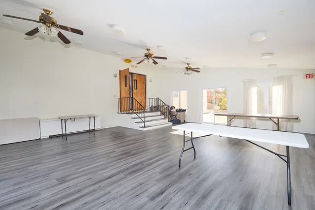 a view of a room with wooden floor