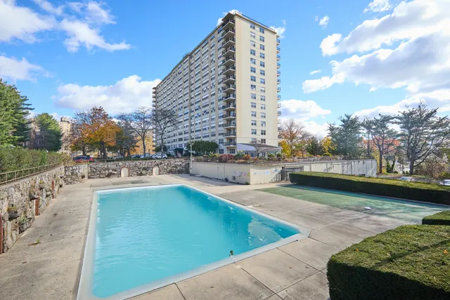 a view of a swimming pool with a lounge chair