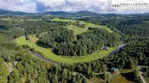 a view of a swimming pool with a yard
