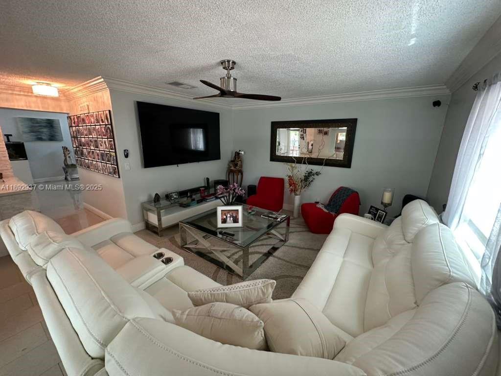 14716 Southwest 111th Terrace Miami, FL 33196 - Photo 11 of 30 a living room with furniture a flat screen tv and a window
