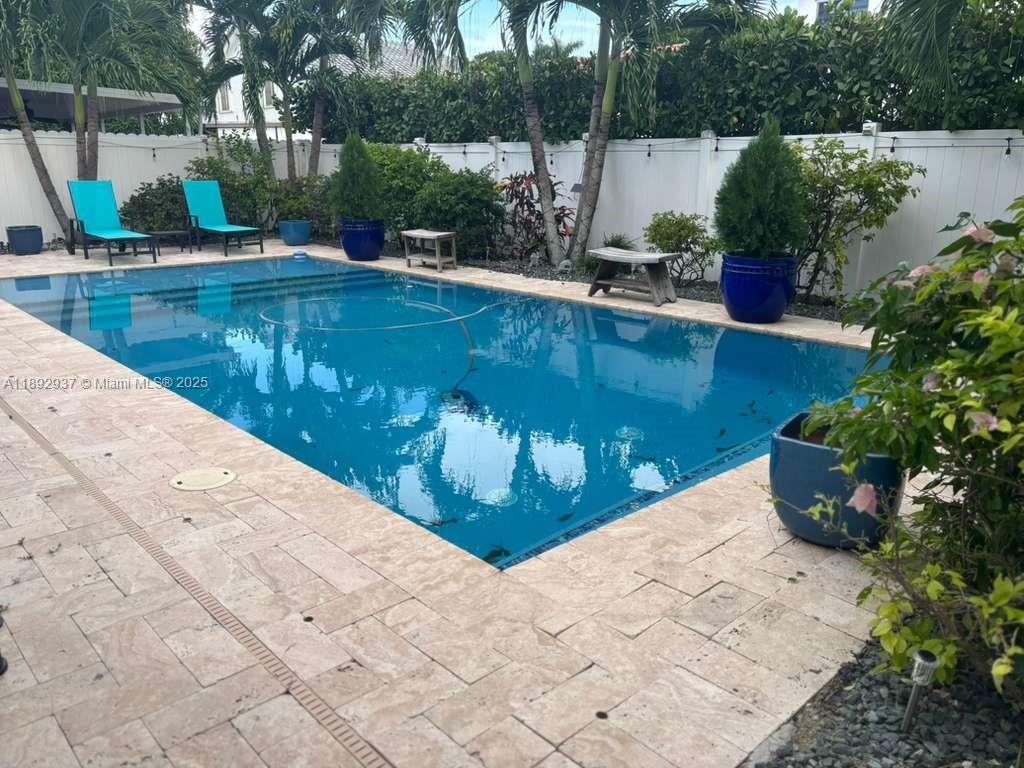 14716 Southwest 111th Terrace Miami, FL 33196 - Photo 18 of 30 a view of a swimming pool with a patio and a garden