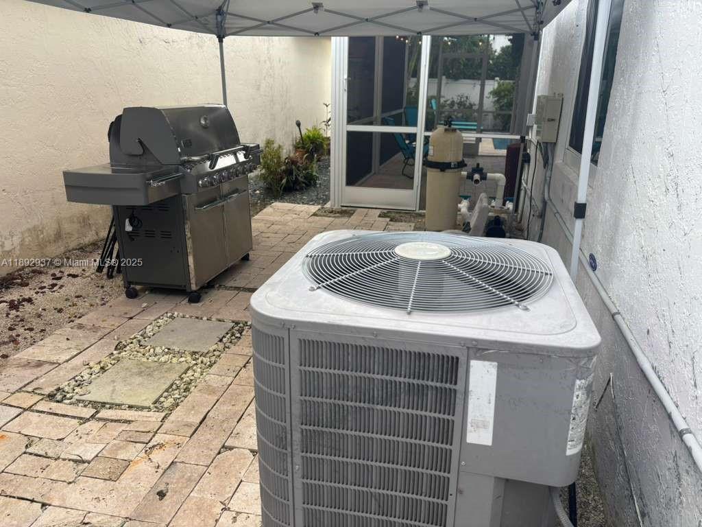 14716 Southwest 111th Terrace Miami, FL 33196 - Photo 19 of 30 a kitchen with a sink a counter top space and a view of living room