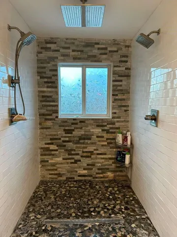 a spacious bathroom with a double vanity sink and a mirror