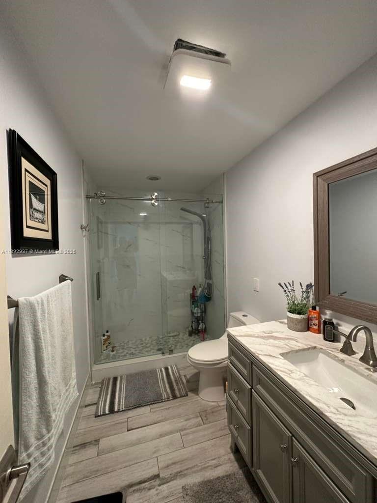 14716 Southwest 111th Terrace Miami, FL 33196 - Photo 27 of 30 a spacious bathroom with a double vanity sink and a mirror