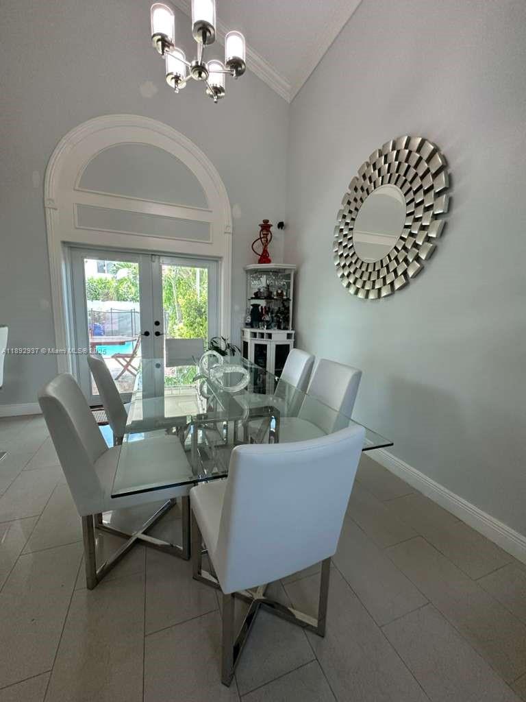 14716 Southwest 111th Terrace Miami, FL 33196 - Photo 30 of 30 a living room with furniture and a chandelier