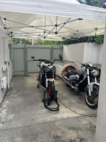 a living room with furniture a flat screen tv and a window