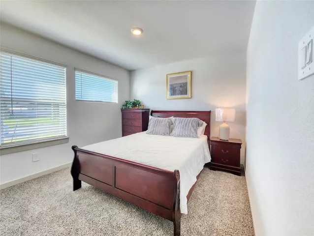 a bedroom with a bed and a night stand