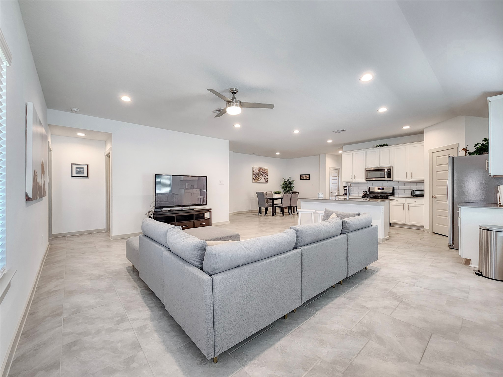 29914 Reagans Rnch Drive Katy, TX 77494 - Photo 17 of 45 a living room with furniture a kitchen view and a refrigerator