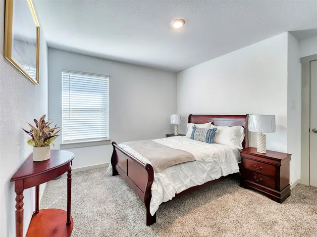 a bedroom with a bed and window