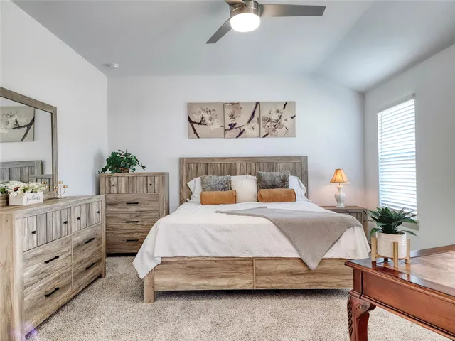 a bedroom with a bed and a dresser