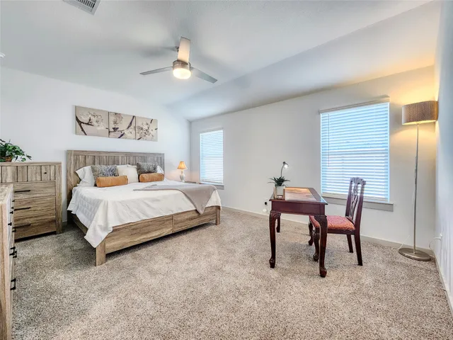 a bedroom with a bed and a chair