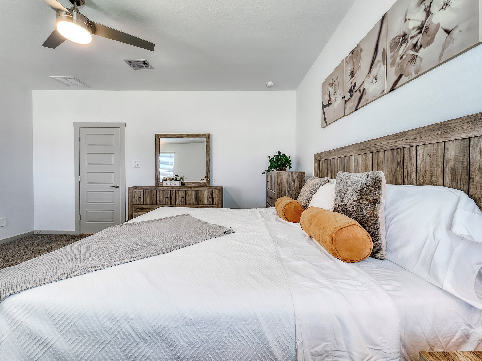 29914 Reagans Rnch Drive Katy, TX 77494 - Photo 31 of 45 a bedroom with a large bed and a chandelier