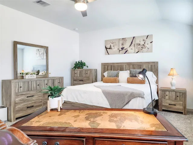 a bedroom with a bed and a mirror