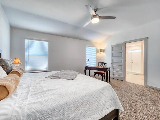 a spacious bathroom with a shower a sink and a mirror