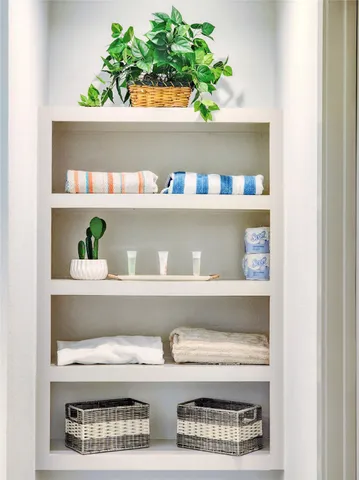 a bathroom with a sink a mirror and a potted plant