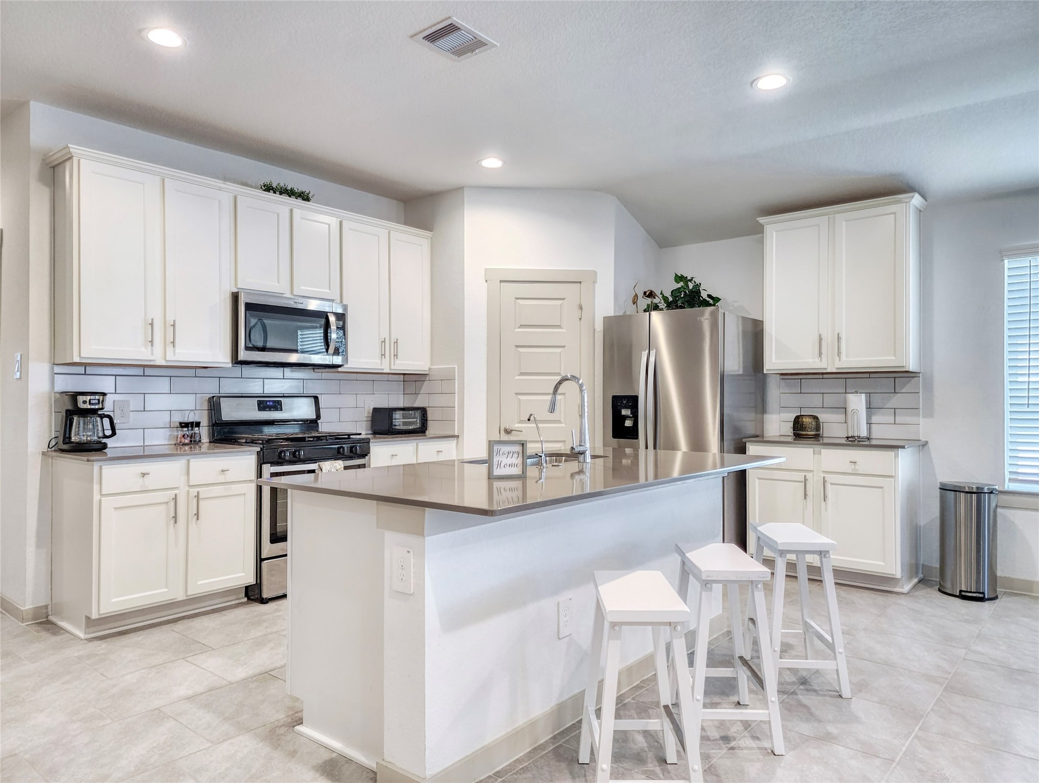29914 Reagans Rnch Drive Katy, TX 77494 - Photo 9 of 45 a kitchen with white cabinets and stainless steel appliances