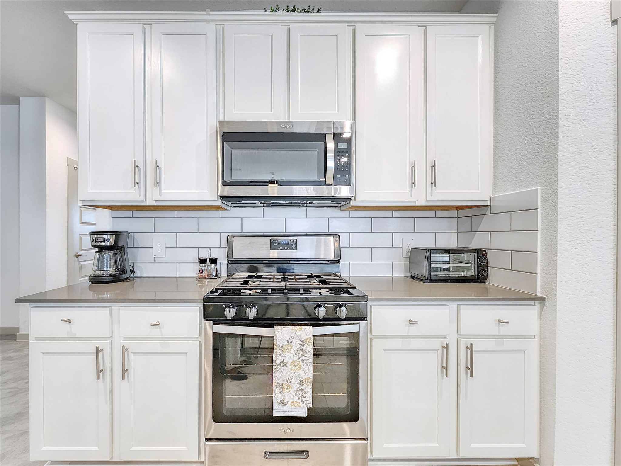 29914 Reagans Rnch Drive Katy, TX 77494 - Photo 10 of 45 a kitchen with white cabinets and appliances
