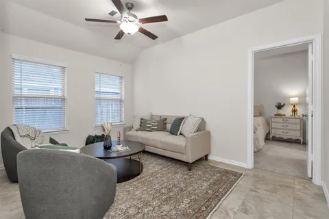 a living room with furniture and a large window