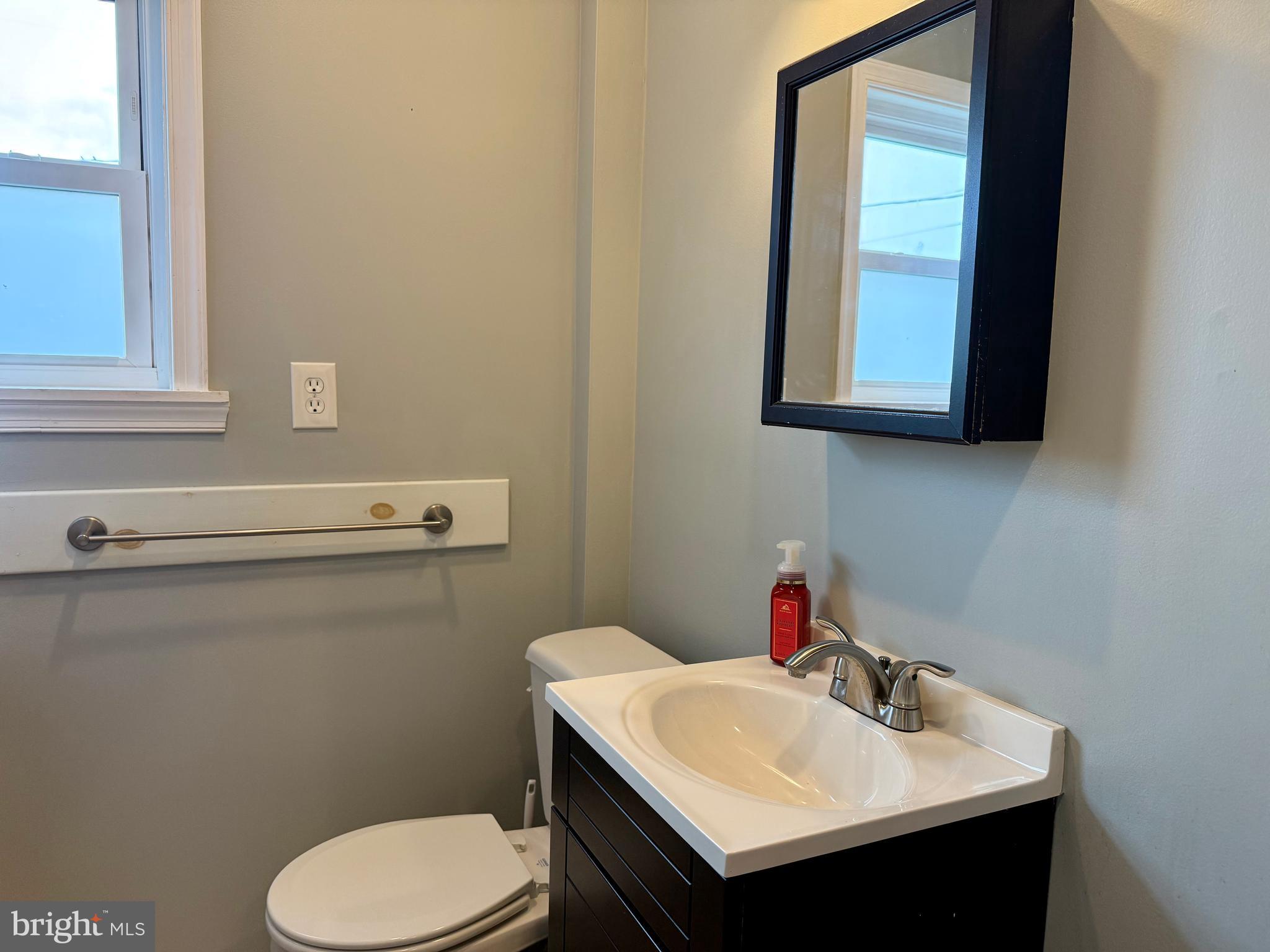 16 Portship Road Baltimore, MD 21222 - Photo 15 of 21 a bathroom with a sink toilet and mirror