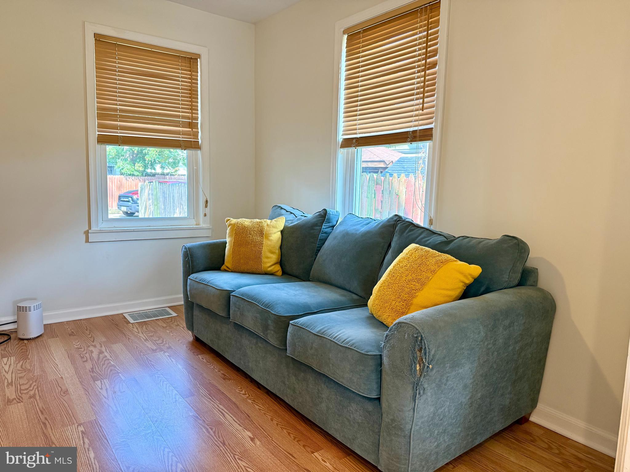 16 Portship Road Baltimore, MD 21222 - Photo 4 of 21 a living room with a couch and a dresser next to a window