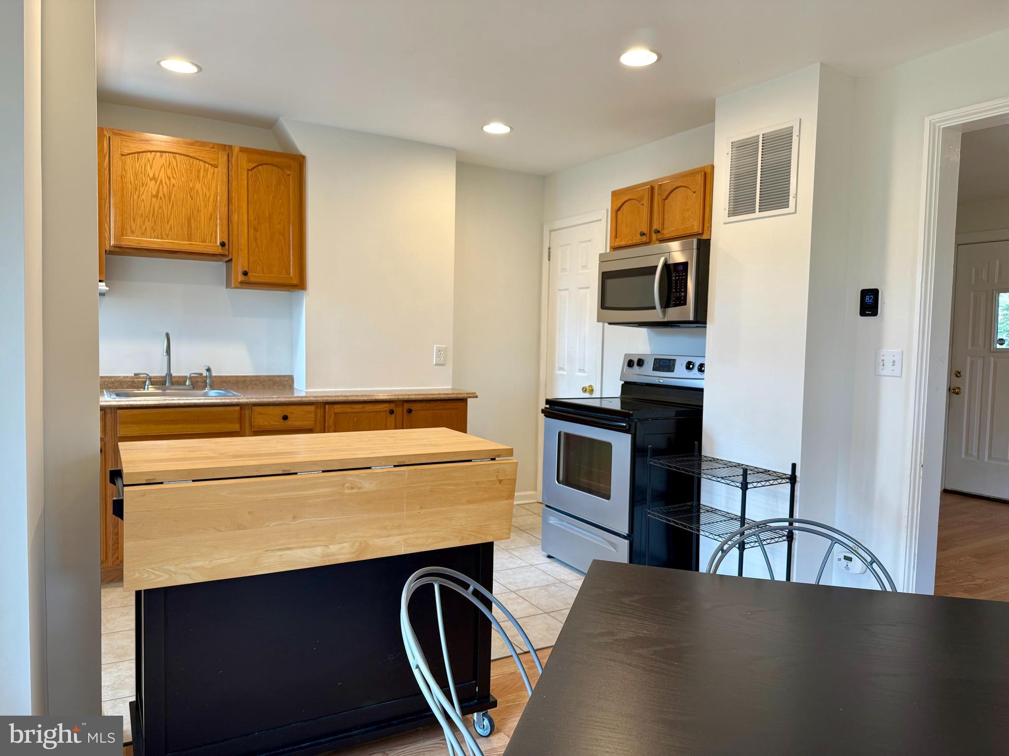 16 Portship Road Baltimore, MD 21222 - Photo 6 of 21 a kitchen with kitchen island a stove and a sink