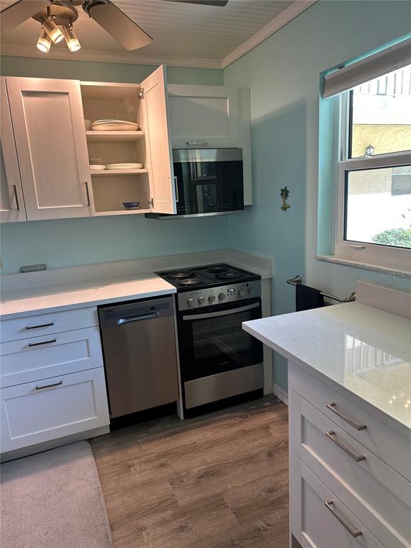 11485 Oakhurst Road, Unit 200114 Largo, FL 33774 - Photo 11 of 40 a kitchen with a stove and a sink