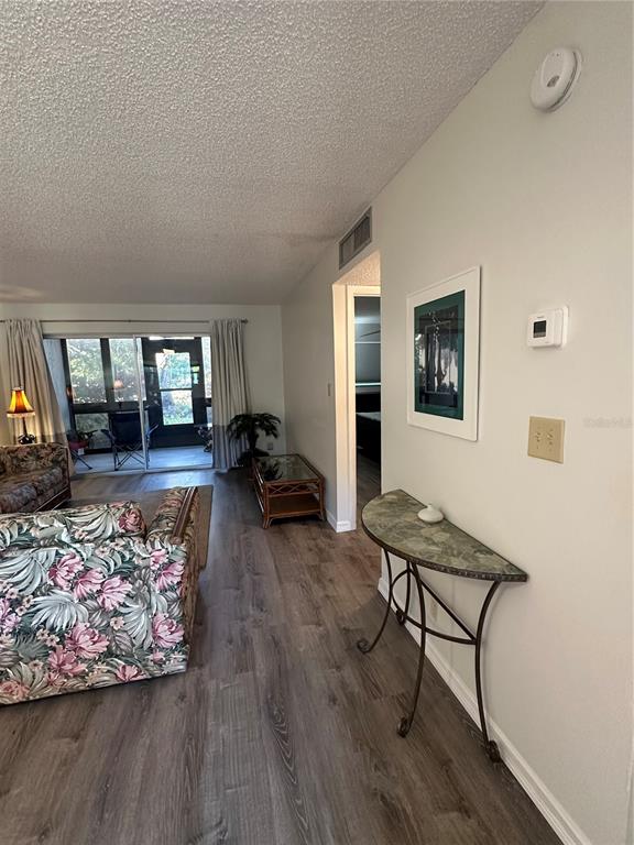11485 Oakhurst Road, Unit 200114 Largo, FL 33774 - Photo 15 of 40 a living room with furniture and a table