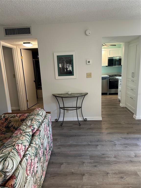 11485 Oakhurst Road, Unit 200114 Largo, FL 33774 - Photo 16 of 40 a bedroom with a bed and a mirror