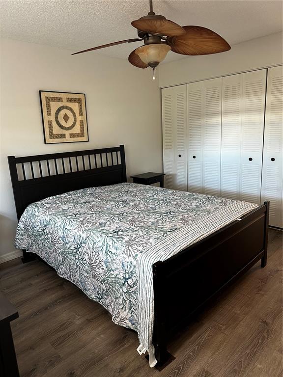 11485 Oakhurst Road, Unit 200114 Largo, FL 33774 - Photo 17 of 40 a bed sitting in a bedroom next to a cabinet