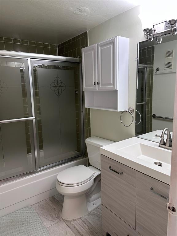 11485 Oakhurst Road, Unit 200114 Largo, FL 33774 - Photo 20 of 40 a white toilet sitting next to a bathroom sink