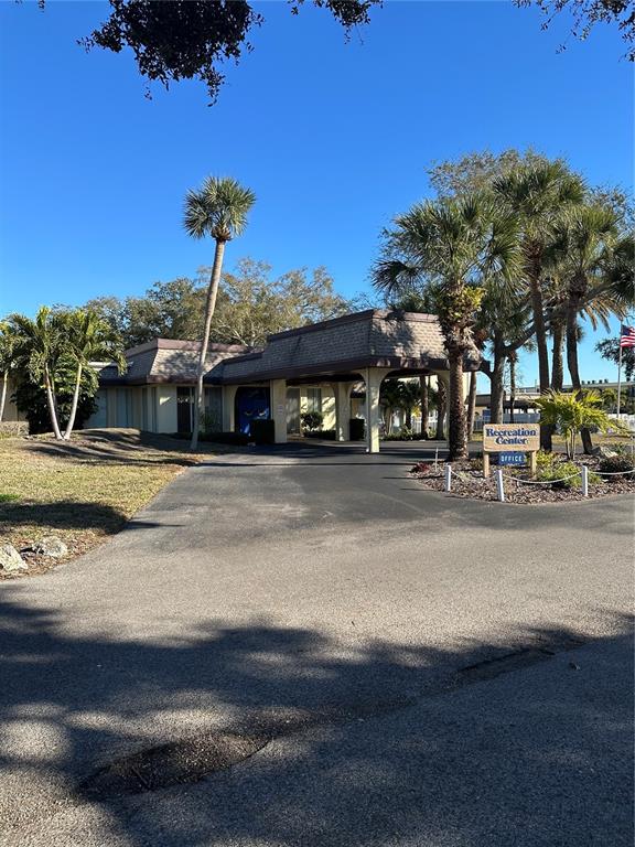 11485 Oakhurst Road, Unit 200114 Largo, FL 33774 - Photo 26 of 40 a front view of a building with a garden