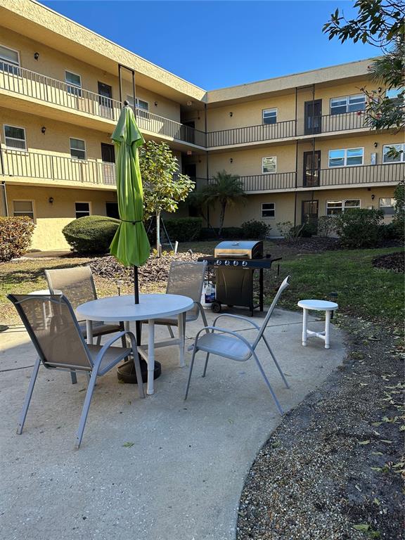 11485 Oakhurst Road, Unit 200114 Largo, FL 33774 - Photo 3 of 40 a view of a patio with a table and chairs