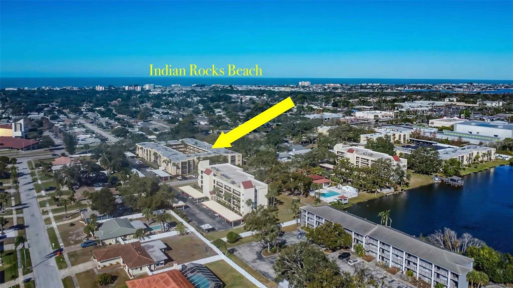 11485 Oakhurst Road, Unit 200114 Largo, FL 33774 - Photo 33 of 40 an aerial view of a house with a swimming pool outdoor seating and lake view