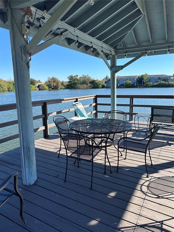 11485 Oakhurst Road, Unit 200114 Largo, FL 33774 - Photo 36 of 40 a view of a chairs and table in the patio