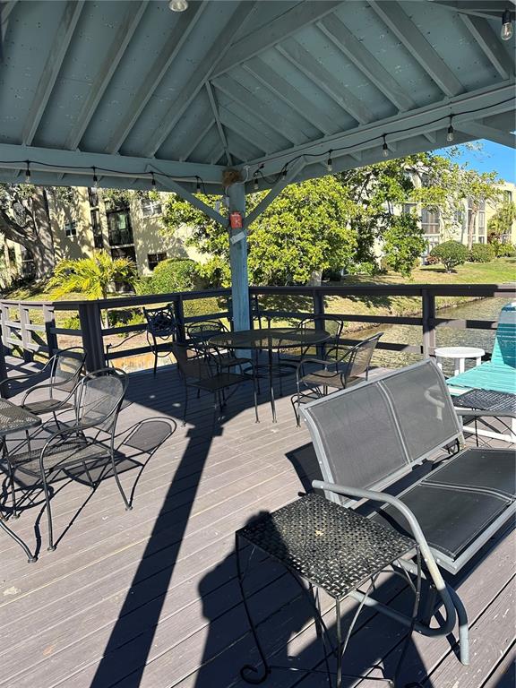 11485 Oakhurst Road, Unit 200114 Largo, FL 33774 - Photo 37 of 40 a view of a tables and chairs in patio