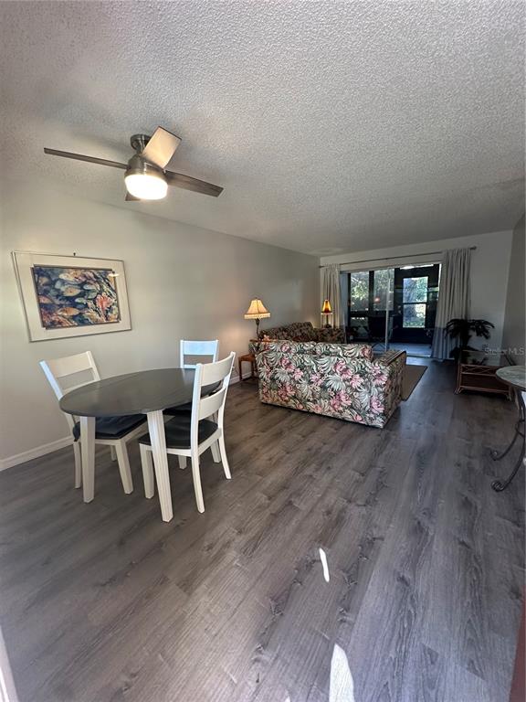 11485 Oakhurst Road, Unit 200114 Largo, FL 33774 - Photo 7 of 40 a view of a dining room with furniture and wooden floor