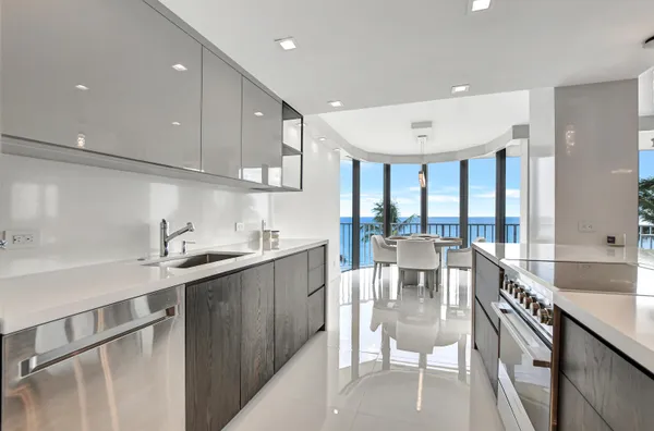 a kitchen with stainless steel appliances granite countertop a sink and a refrigerator