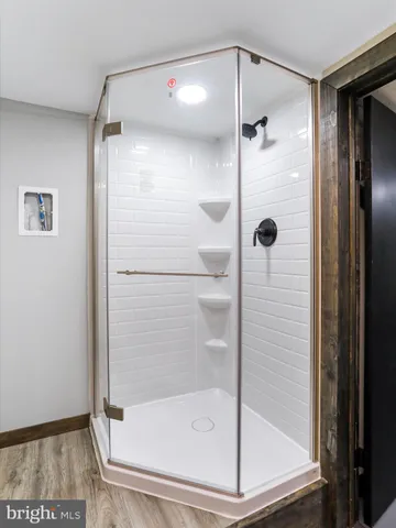 a bathroom with a glass shower door